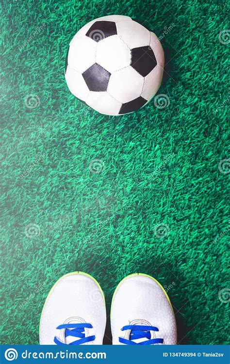 Soccer Ball And Cleats Against Green Artificial Turf Stock
