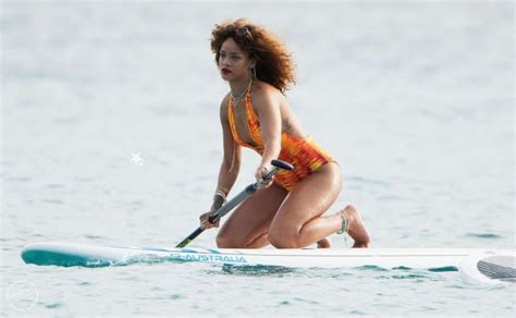 Rihanna Wears Flame Coloured Swimsuit While Paddleboarding In Barbados