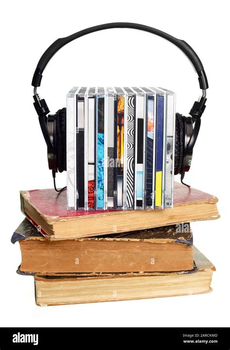 Stack Of Cds With Hi Fi Headphones And Old Books On White Background