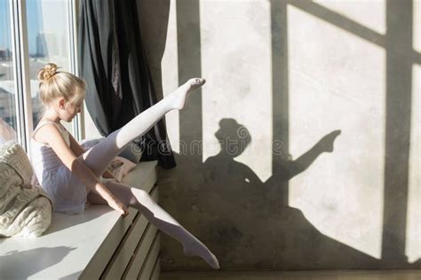 Little Ballet Dancer Doing Stretching Before Exercise Stock Photo