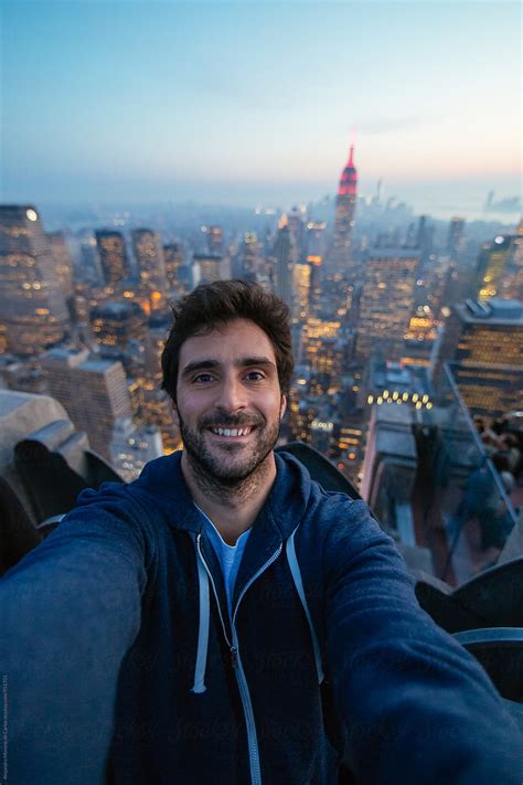 Young Man Taking A Selfie On A Rooftop With The View Of