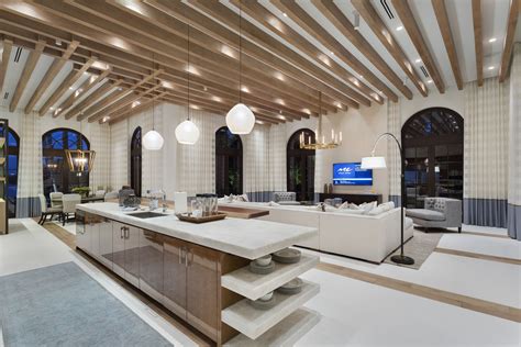 A Large Open Living Room With High Ceilings And Wooden Beams On The