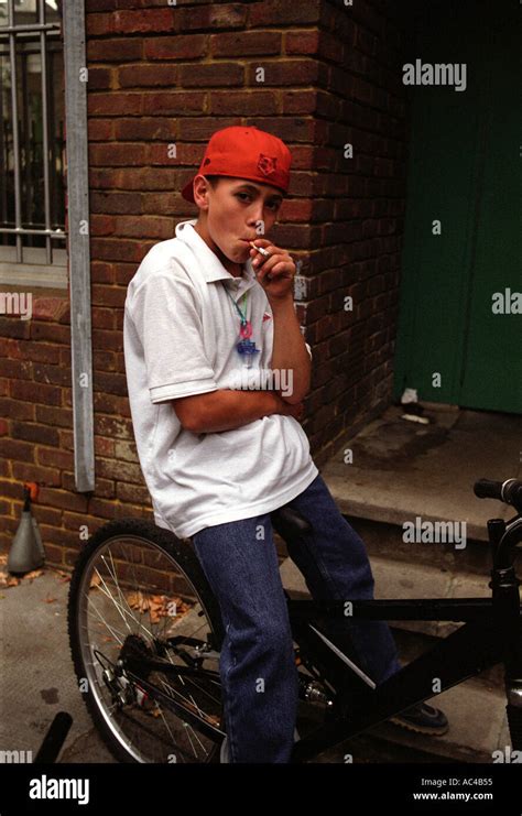 Young Boy Smoking And Hanging Around On Bikes On A Housing