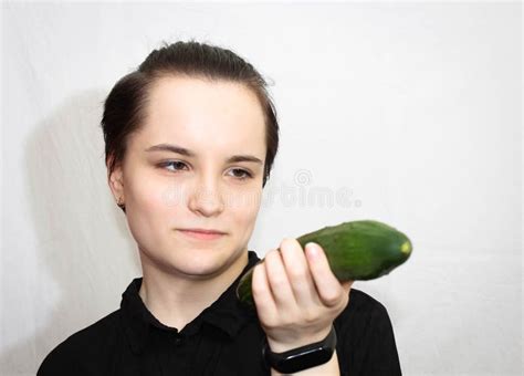 The Girl Keeps A Whole Fresh Cucumber For Eating During The Diet Stock