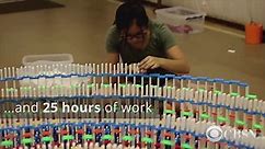 Triple spiral of dominoes falling mesmerizes the internet