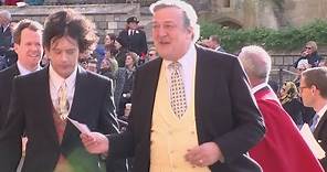 Stephen Fry arrives with husband Elliott Spencer for royal wedding
