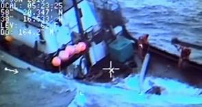 Alaskan fishermen rescued from sinking ship – video