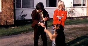 George and Angie Best play with their German Shepherd dog
