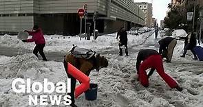 Madrid citizens help troops clean up snow as storm paralyzes airports, roads
