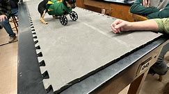 Menard robotics team makes wheelchair for puppy without front legs