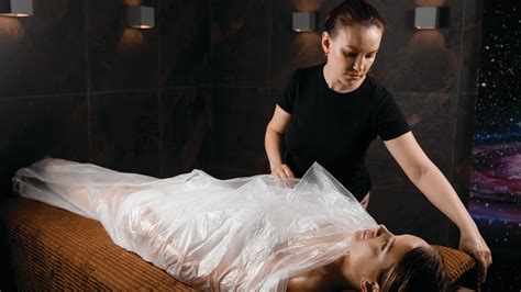 Woman getting a body wrap at spa