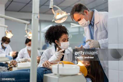 Dentist examining a student