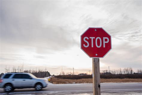 How far do you stop in front of a stop sign
