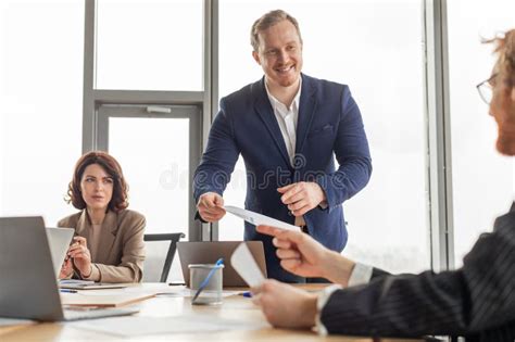 Man in suit presenting document