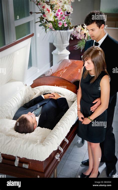 Man looking at a coffin