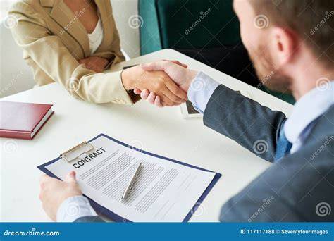 People Shaking Hands over Contract