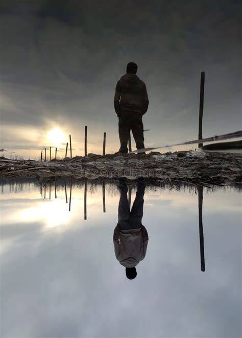Person looking at their reflection in water