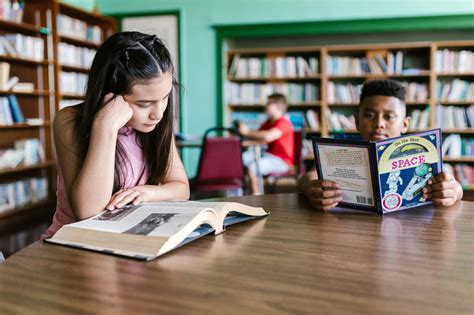 Student reading books in library
