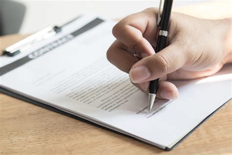 Student signing document