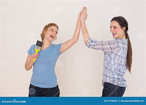 Two friends giving high five