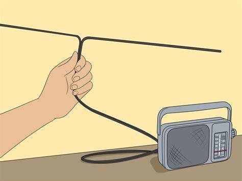 A person's hand adjusting a telescoping antenna on a small portable radio