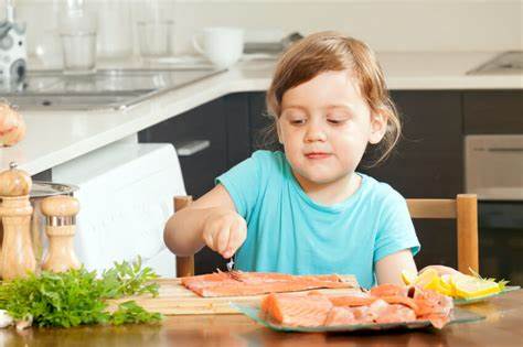 child eating salmon