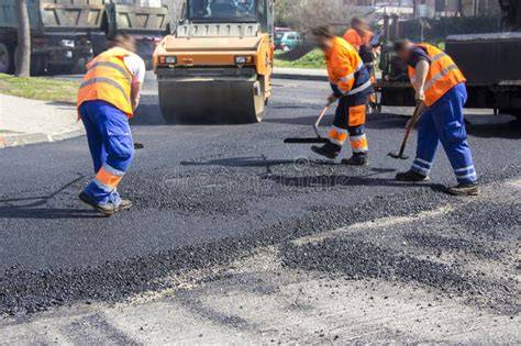 Construction workers repairing road