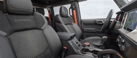 Interior shot of a modern Ford Bronco, showcasing the infotainment screen and durable materials