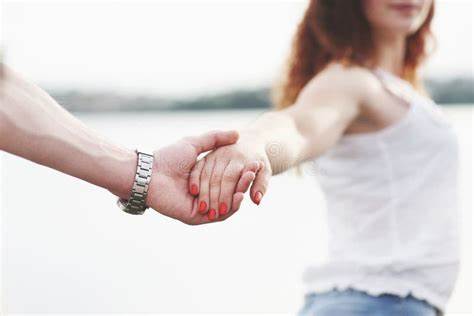 girl holding boyfriend's hand