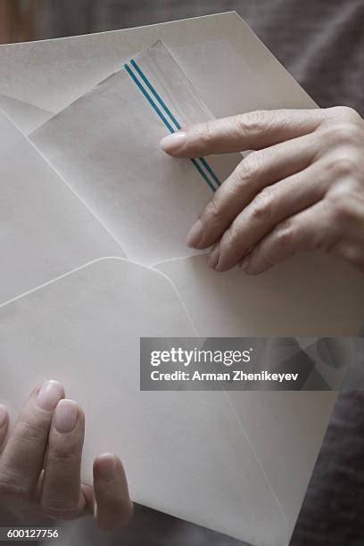 hand putting letter in envelope