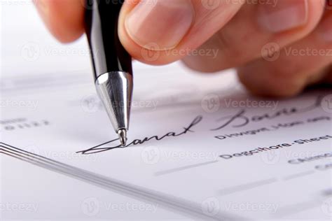 A hand signing a document with a pen, implying official endorsement