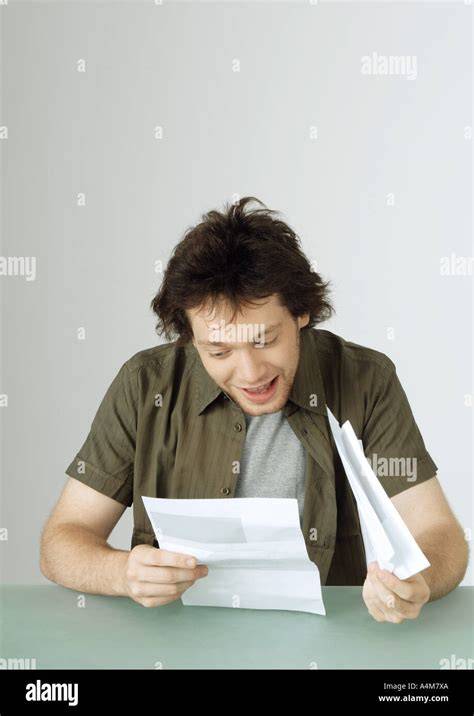 man reading a letter smiling