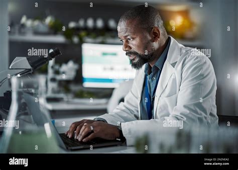 Person researching on a computer, with various books and documents around