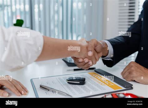 A person signing a contract while discussing with another person