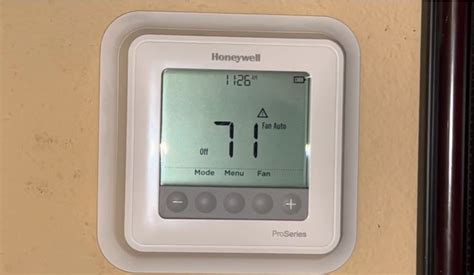what does triangle with exclamation point mean on thermostat