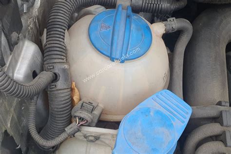 why is coolant coming out the overflow tank